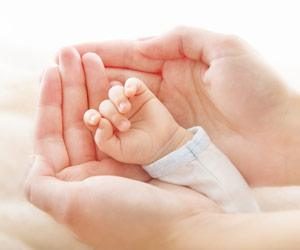 Holding infant hands