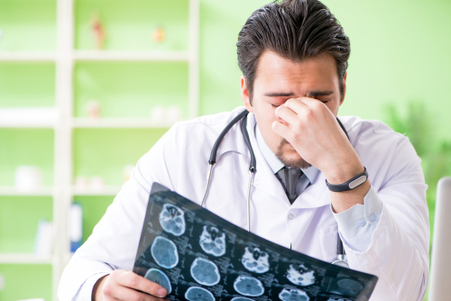 Doctor reviewing brain scans for medical negligence case