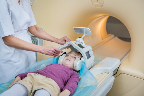 Child preparing for brain MRI after birth injury