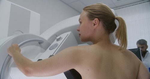 Woman undergoing breast imaging for cancer diagnosis