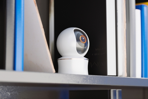 Hidden spy camera on a bookshelf