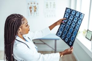 Doctor reviewing a brain scan to evaluate a traumatic brain injury