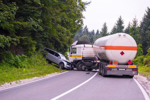 Tanker truck and passenger car crash on roadway