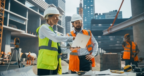 Construction workers reviewing plans at a job site in Chicago