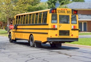 Yellow school bus outside a high school illustrating the Stevenson High School school bus accident in Lincolnshire